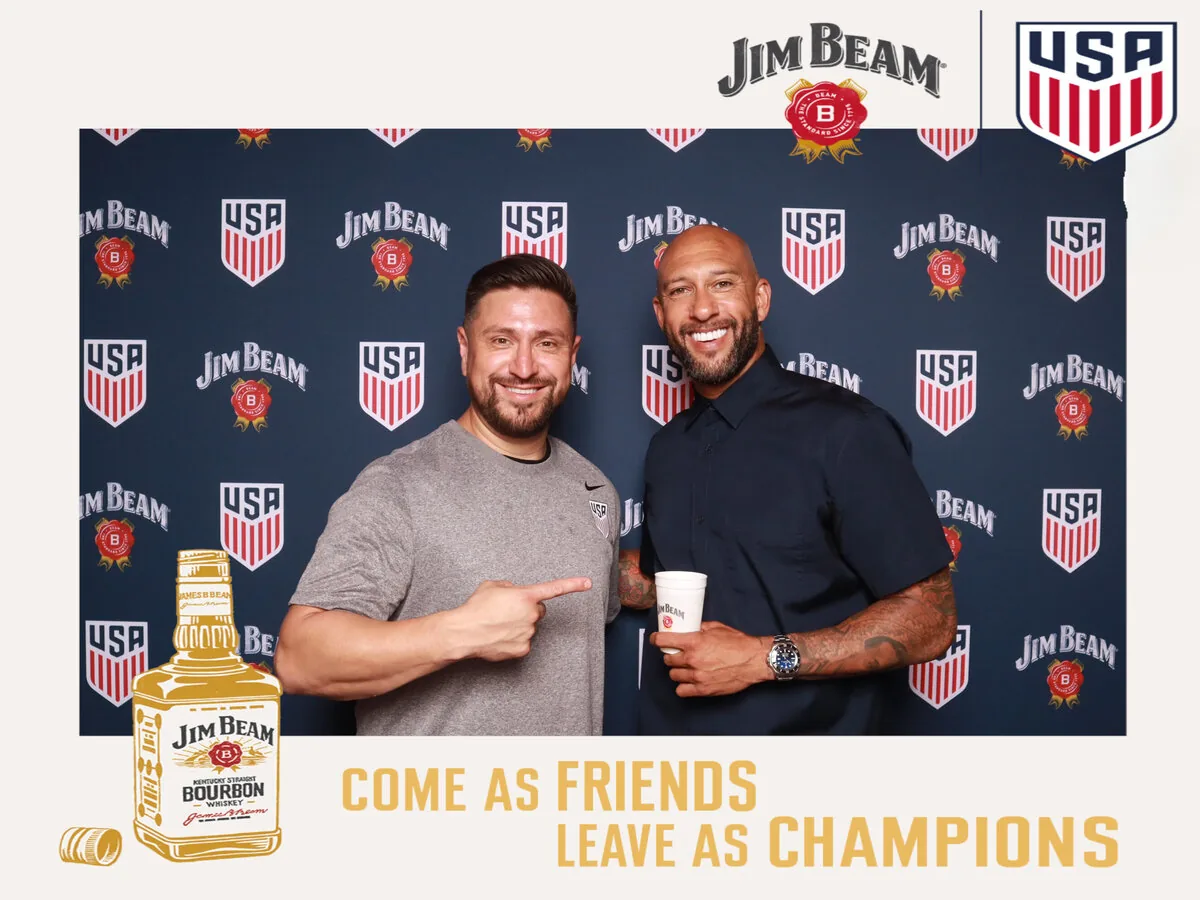 Orlando corporate photo booth experience with a branded step-and-repeat backdrop as guests pose for prints